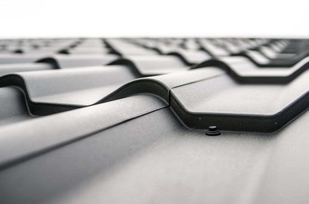 About Close-up view of a metal roofs wavy design showcasing rivets and structural detail.